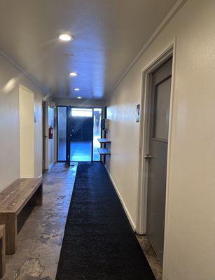 Hallway leading into the main studio. Men's locker room is the door on the right, the women's on the left.