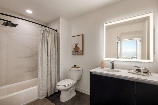 Large mirrors and expansive vanity space in bathrooms