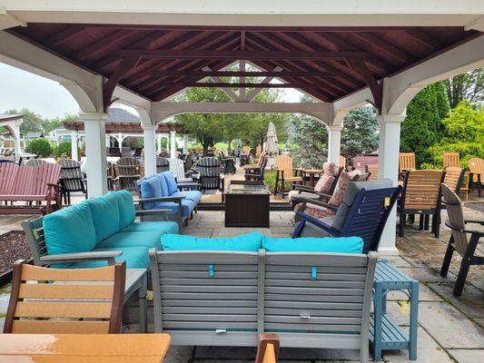 Poly deep seating furniture from under A-frame pavilion on outdoor patio.