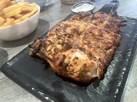 Grilled Chicken with garlic and fries .