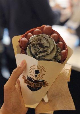 the cauldron ice cream in a red velvet puffle cone