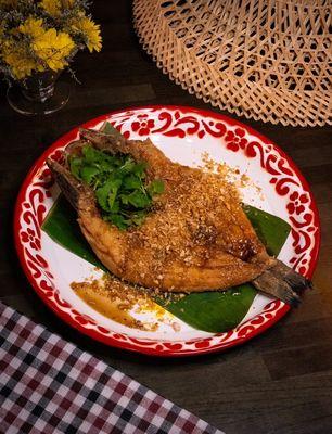 Pla Tod 
Fried branzino whole fish in garlic soy sauce with scallions, cilantro and fried garlic