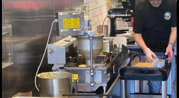 Donut machine making fresh made-to-order donuts