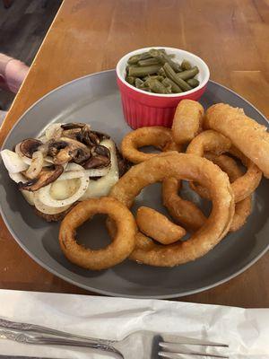 Smothered hamburger, green beans and onion rings.