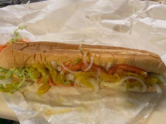 Cheesesteak Hoagie with lettuce, tomato, onions and banana peppers