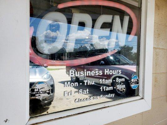 Open sign and business hours at the CHICKEN SHACK in Woodbury, Georgia.