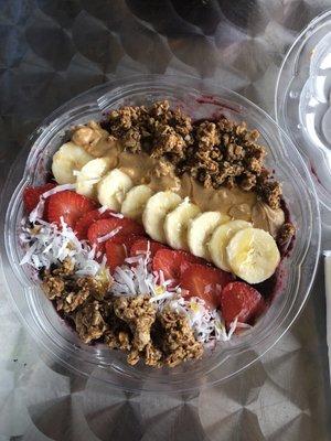 Açaí Bowl strawberries, banana, coconut and peanut butter. All bowls come with honey and granola.