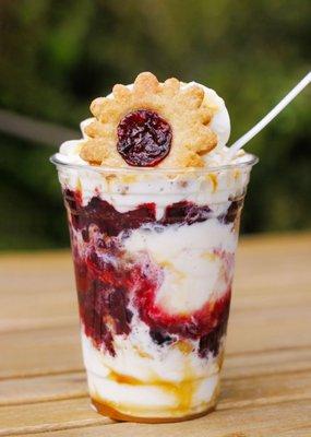 Mixed Berry Pice Cream, contains Vanilla Bean ice cream with layers of our Mixed Berry Jelly Jar pie, caramel drizzle, and whipped cream!