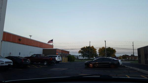 The entrance to the building coming out from the back of parking lot