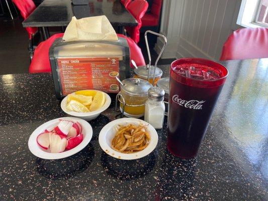 Appetizers served on your table for free and drink called jamaica