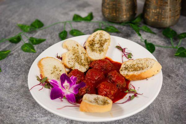 Spanish meatballs with a combination of pork, beef and chorizo served with San Marzano plum tomatoes.