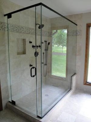 Custom seated shower with body jets and glass surround (the window is actually a reflection off the glass)