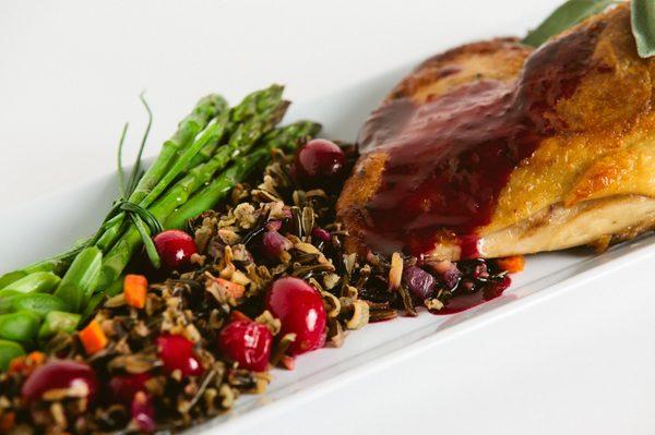 Atikis Flight Caterings toasty duck with blue berry jus and Mn wild rice pilaf