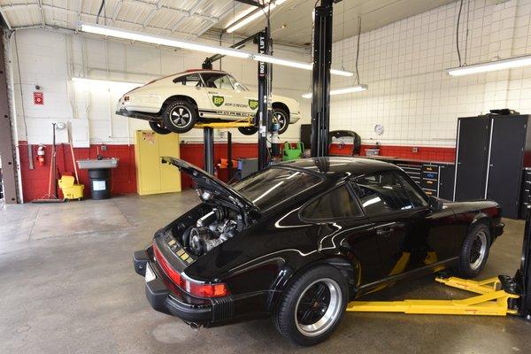 My car in the foreground of this immaculate shop, and check out the 911R on the hoist behind.