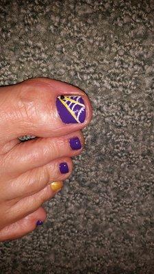 Halloween pedicure!  Don't miss the little spider...