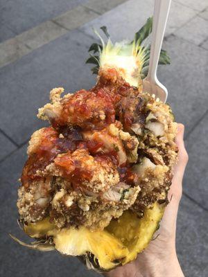 Half a pineapple overflowing with delicious chicken