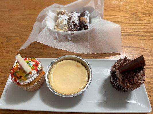 Cannolis, Cheesecake, Vanilla and Chocolate Cupcakes.