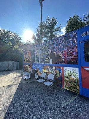 Outside the food truck in the parking lot of the Sunoco