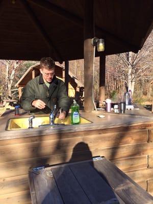 My husband cooking at the camping kitchen.