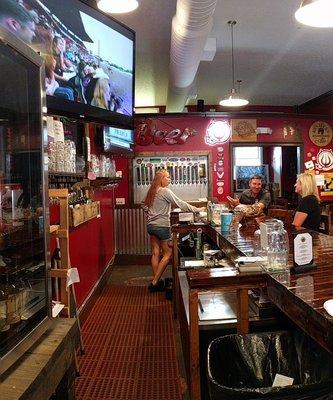 View behind bar toward the tap wall