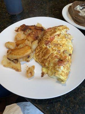 Portuguese omelet (linguica sausage, tomato, onion, cheese) and tasty home fries with side of dark rye toast