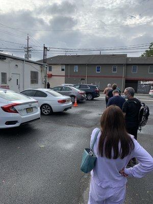 Line behind the building in the parking lot