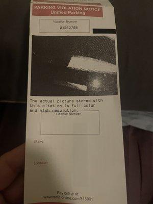 Photo of ticket clearly showing we had the ticket on the dashboard bbt the Tacoma has a deep dashboard that made the ticket fall sideways