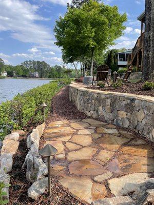 Fishing pad, retaining wall, and lakeside walk.