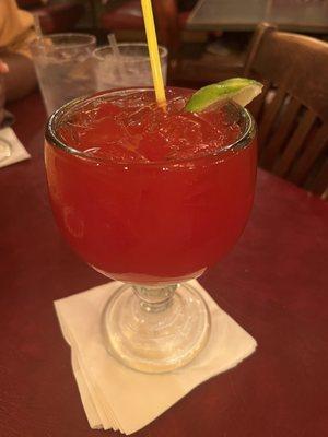 Top shelf strawberry margarita on the rocks.