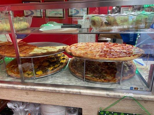 Variety of toppings: Penne Vodka, White, Cheeseburger, Pepperoni, Sausage with peppers and onions, along with Grandma & Sicilian