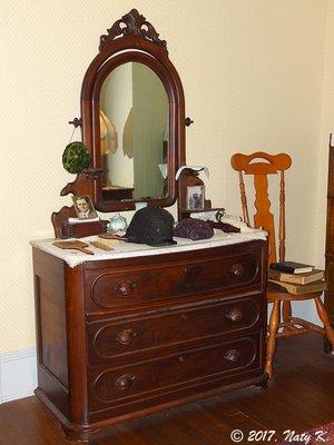 Dresser in the bedroom.  None of the original furnishings exist, so the furniture you see is meant to represent their belongings.