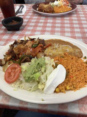 Two Beef, chicken, shrimp flower tocos with sour cream lettuce ,avocado topping.  Refried beans and yummy rice.