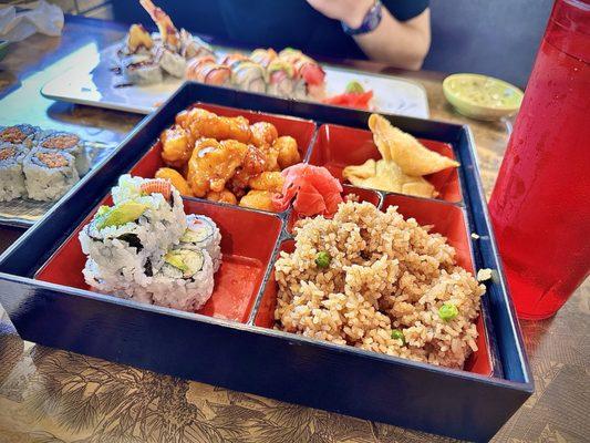 Bento with General Tso's Chicken, Shrimp Rangoon, Fried Rice, California Roll and an Egg Roll.