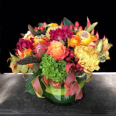 Autumn colors in leaf wrapped cut glass cylinder.