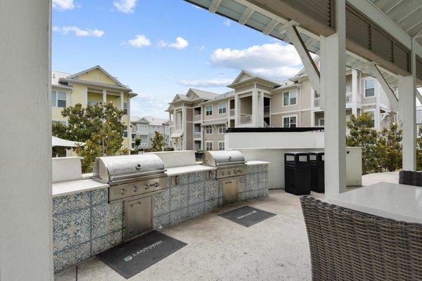 Outdoor grill area with two grills and outdoor seating at Lantower Edgewater