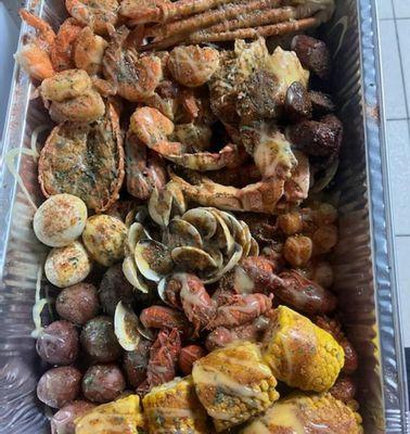 Seafood boil. (Shrimp, big snow crabs, Dungeness crabs, lobster, classic, crawfish, sausage, corn, potatoes, & eggs)