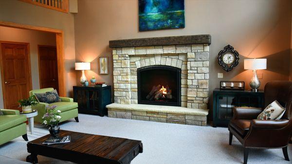 A brighter, large stone design, barn beam mantle, and a Heat&Glo gas fireplace.
Creating an updated fireplace to fit the large space.