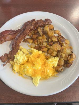 2 scrambled eggs with cheese, bacon and home fries.