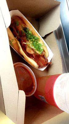 Bacon cheddar hot dog with chipotle BBQ sauce and a beer.