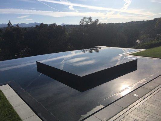 Mission Viejo pool and spa renovation with new a new black pebble pool surface, new tile and new coping.