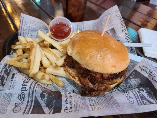 Pulled pork sandwich with a side of fries