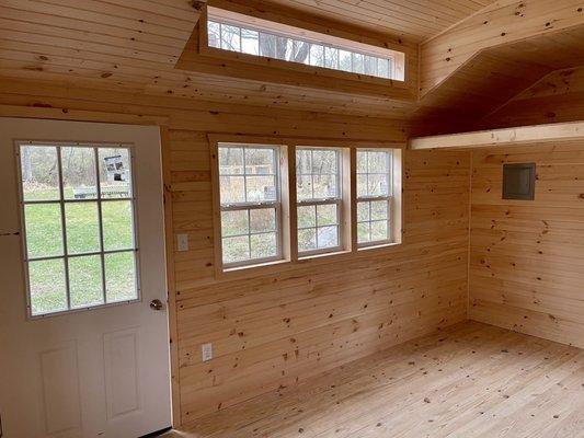 Custom shed insulated with added electrical package and finished with tongue and groove board for an office / guest space.