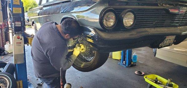 Master ASE Technician fixing a Dayton wheel another shop cross threaded.