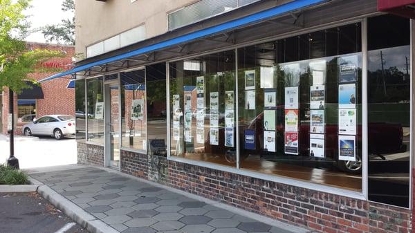 Front Windows of the office displaying some local properties.