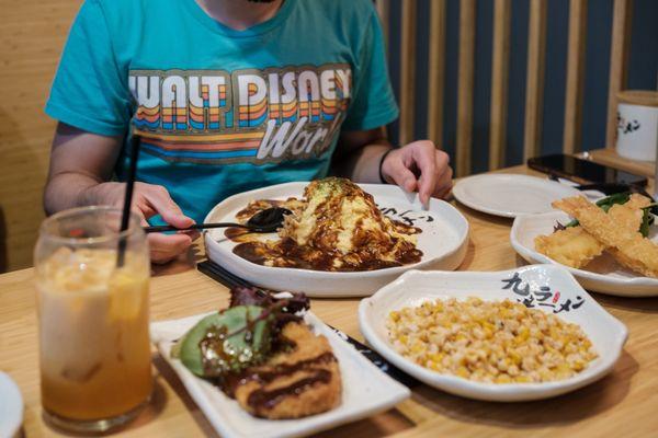 Tonkatsu (pork chop), Salt & Pepper Crispy Corn (right), and Omurice (background)