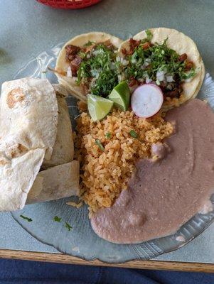 Burrito with Al Pastor, A carnitas taco, and a marinated pork taco