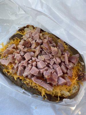 Smoked potato with smoked ham, butter, cheese, & sour cream!