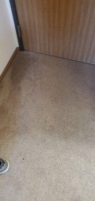 Dirty carpet by the door.