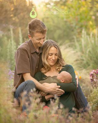 Family with their newborn baby during an garden newborn photography session with Diane Bartoo