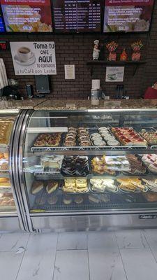 Display case with some cakes and pastry